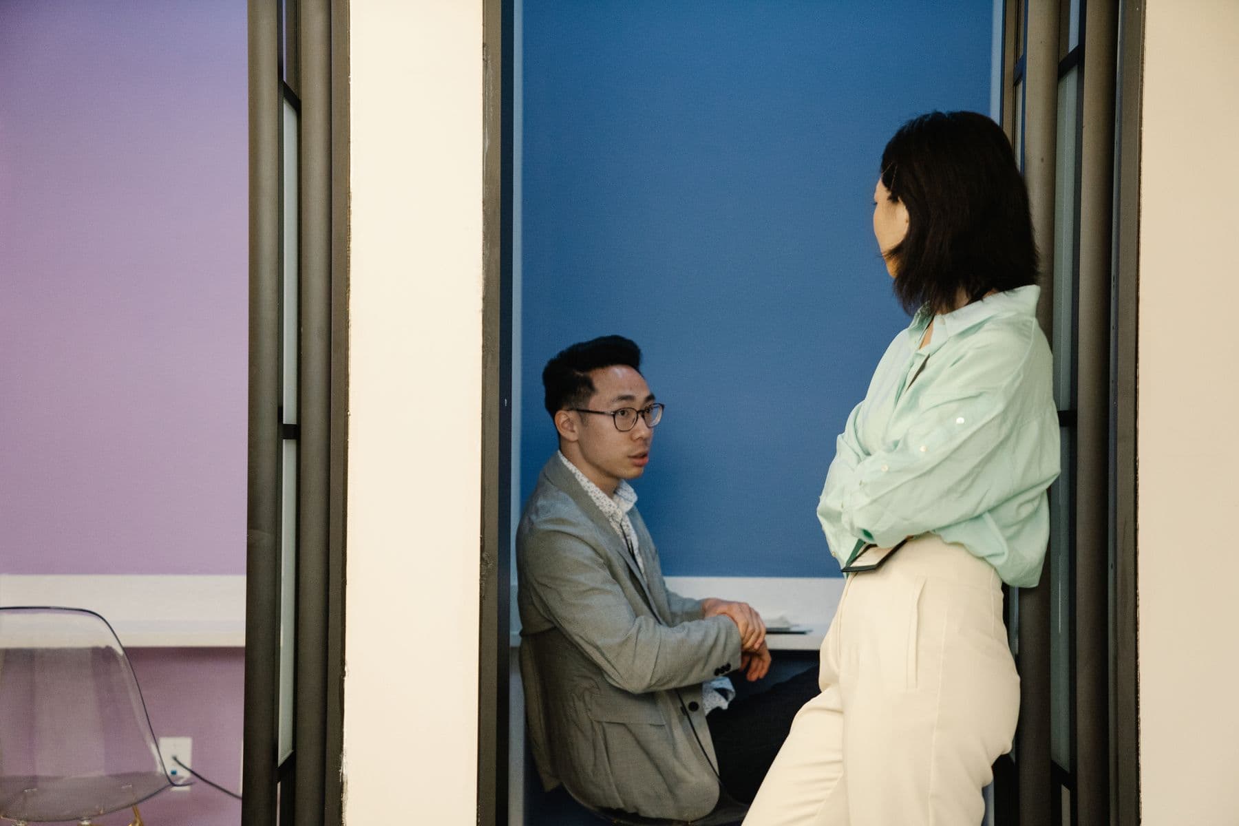 Two people talking in a doorway